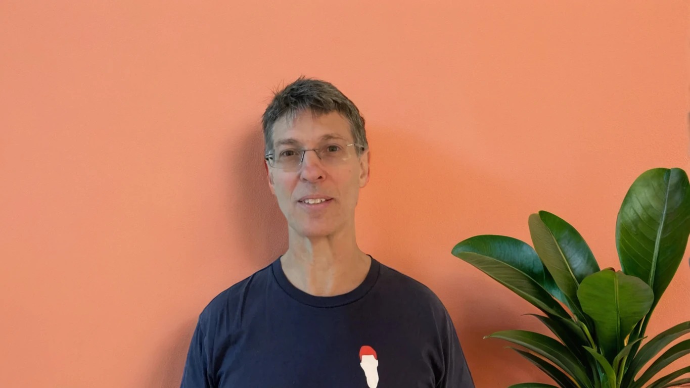 Charles Reiss with an orange background