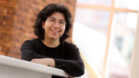Doina Precup in foreground with a blurred background